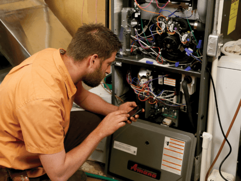 HVAC technician repairing a residential furnace unit